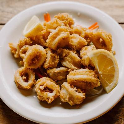 Golden fried calamari served with fresh lemon