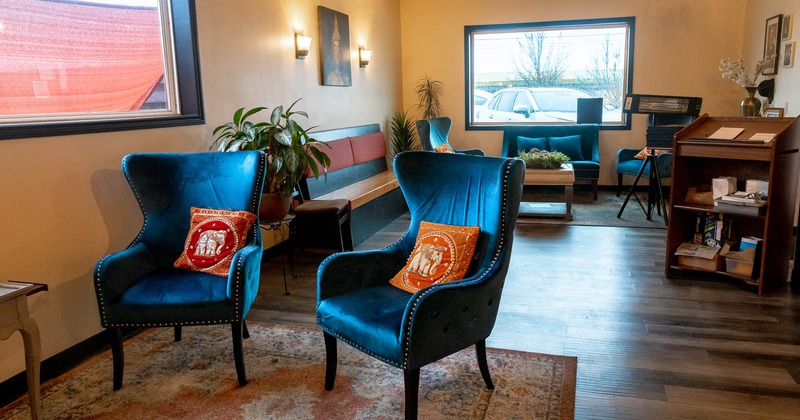 Blue armchairs and a low table in the Sala Thai lounge area