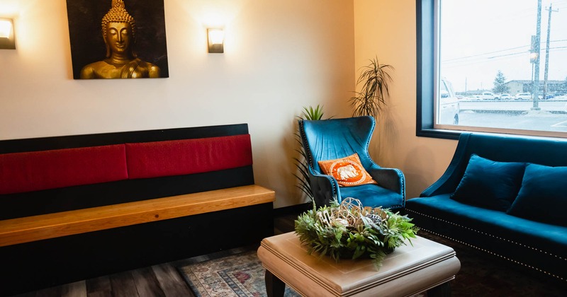 Corner seating with a Buddha statue and traditional Thai decor