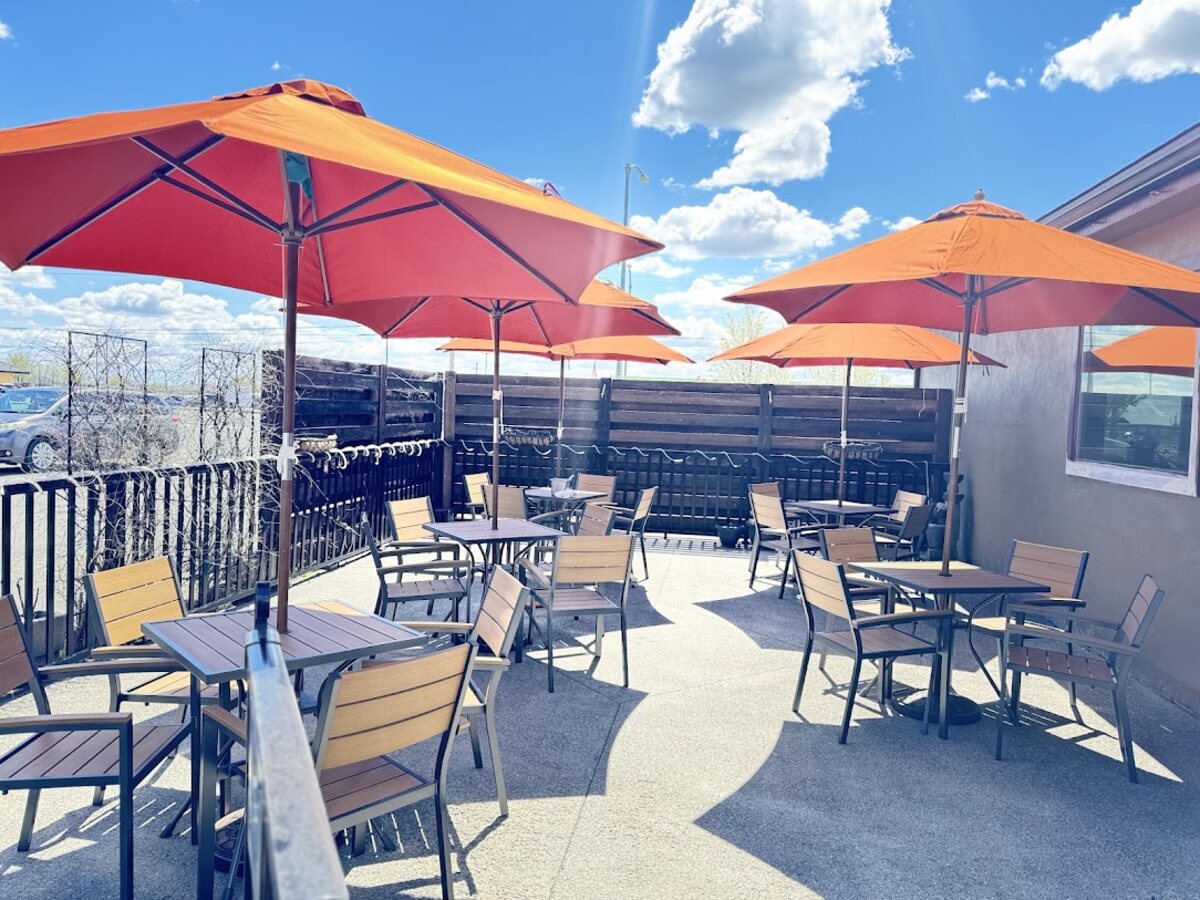 Sala Thai's outdoor patio with red umbrellas and table seating